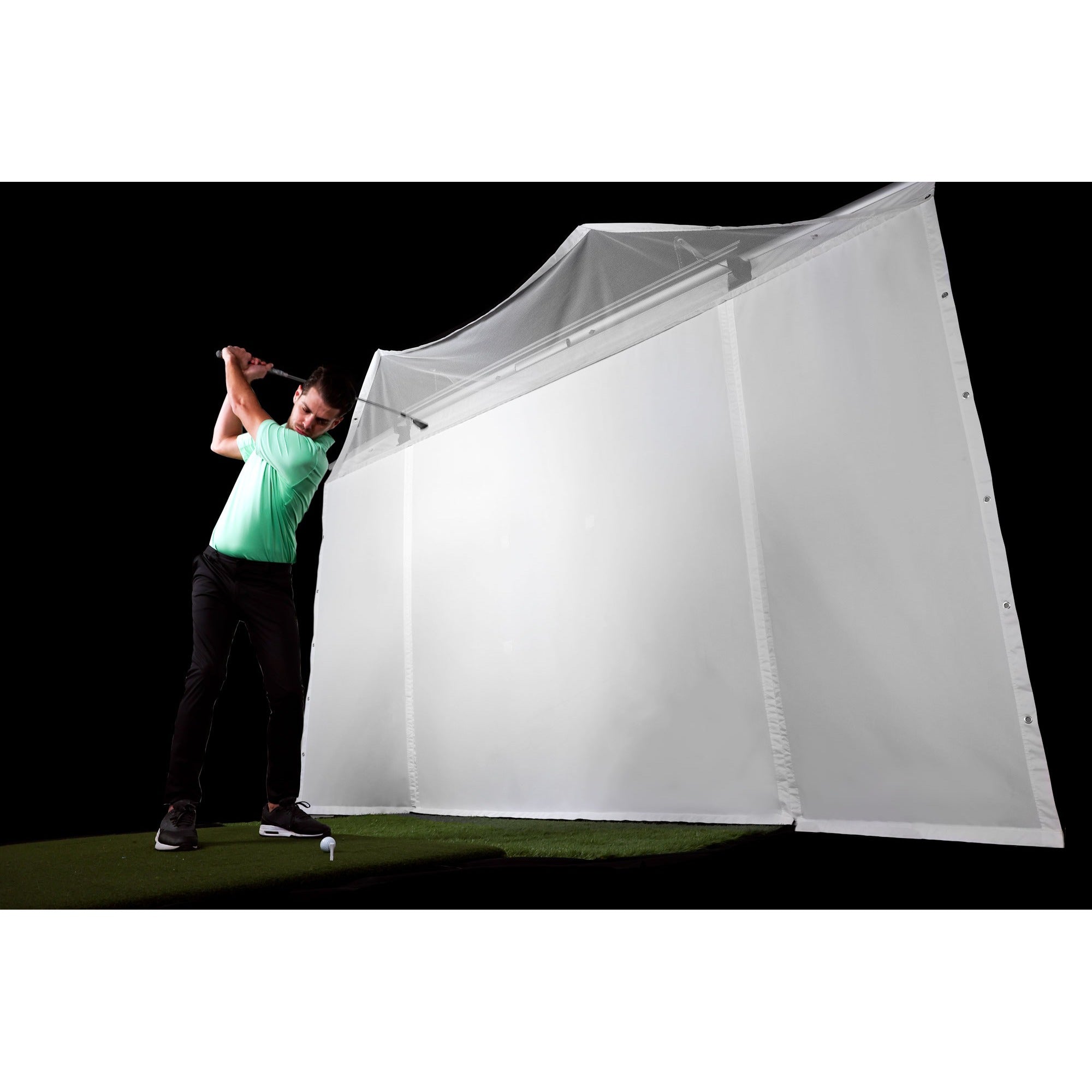 Golfer playing on HomeCourse Golf ProScreen 180 indoor golf simulator