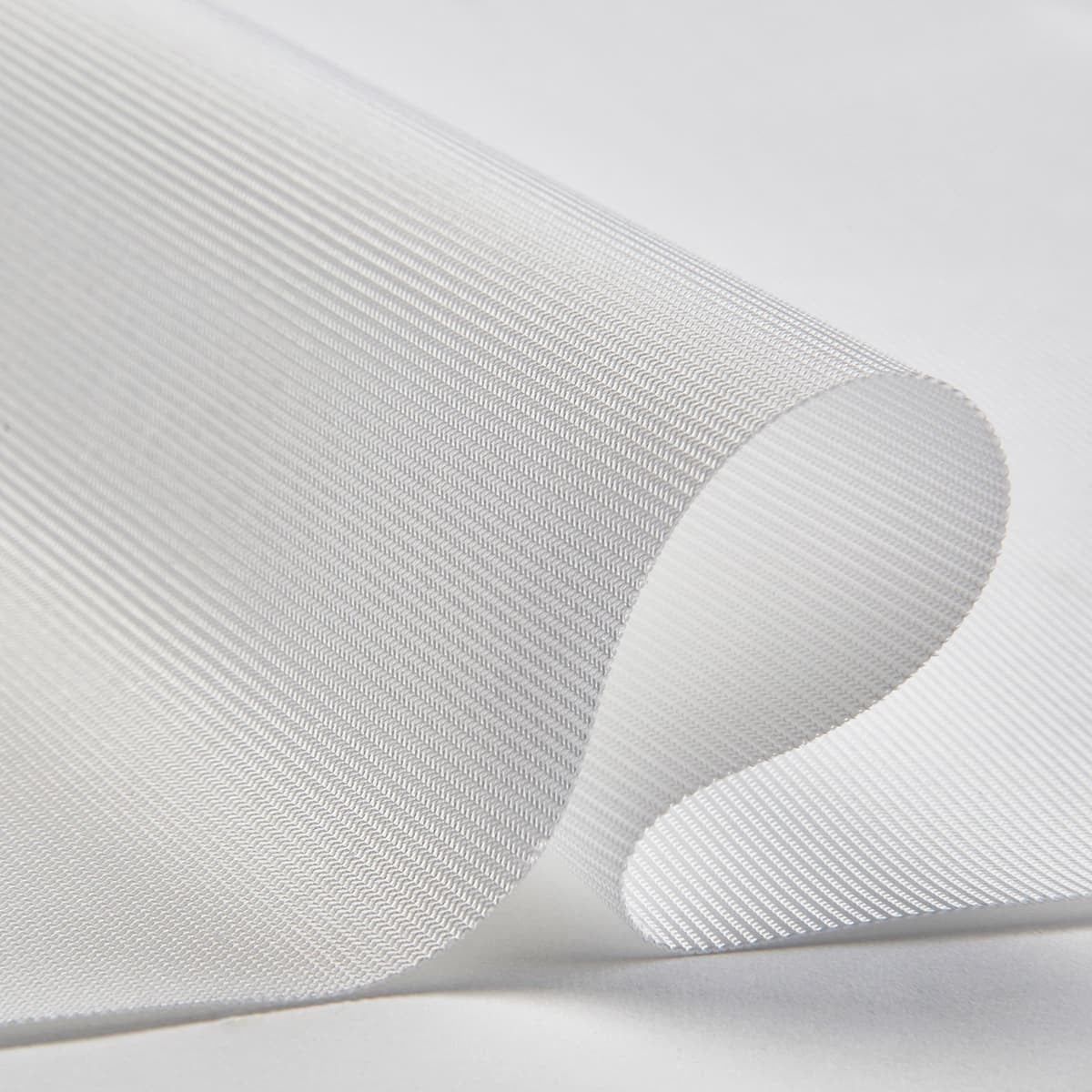 Carl's Place Preferred Impact Screen - close-up of the white screen fabric curled to show its fine ribbed weave