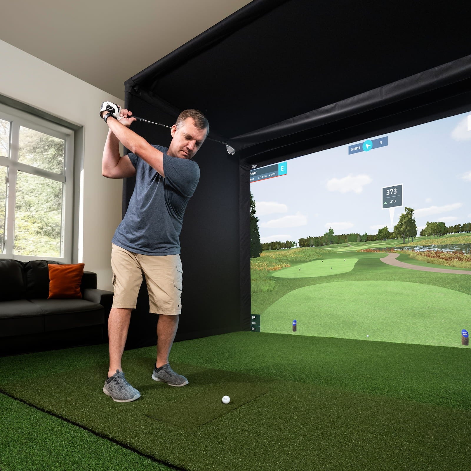 Carl's Place Pro Golf Enclosure Kit - golfer mid-swing in a commercial simulator bay