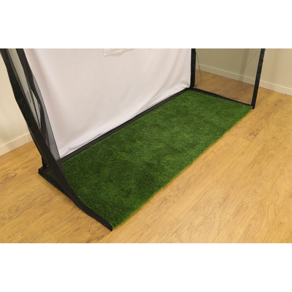 HomeCourse Golf Practice Landing Mat green turf on hardwood floor in front of practice net